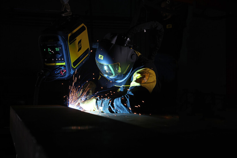 A person wearing Sentinel helmet and welding with RobustFeed Pro.