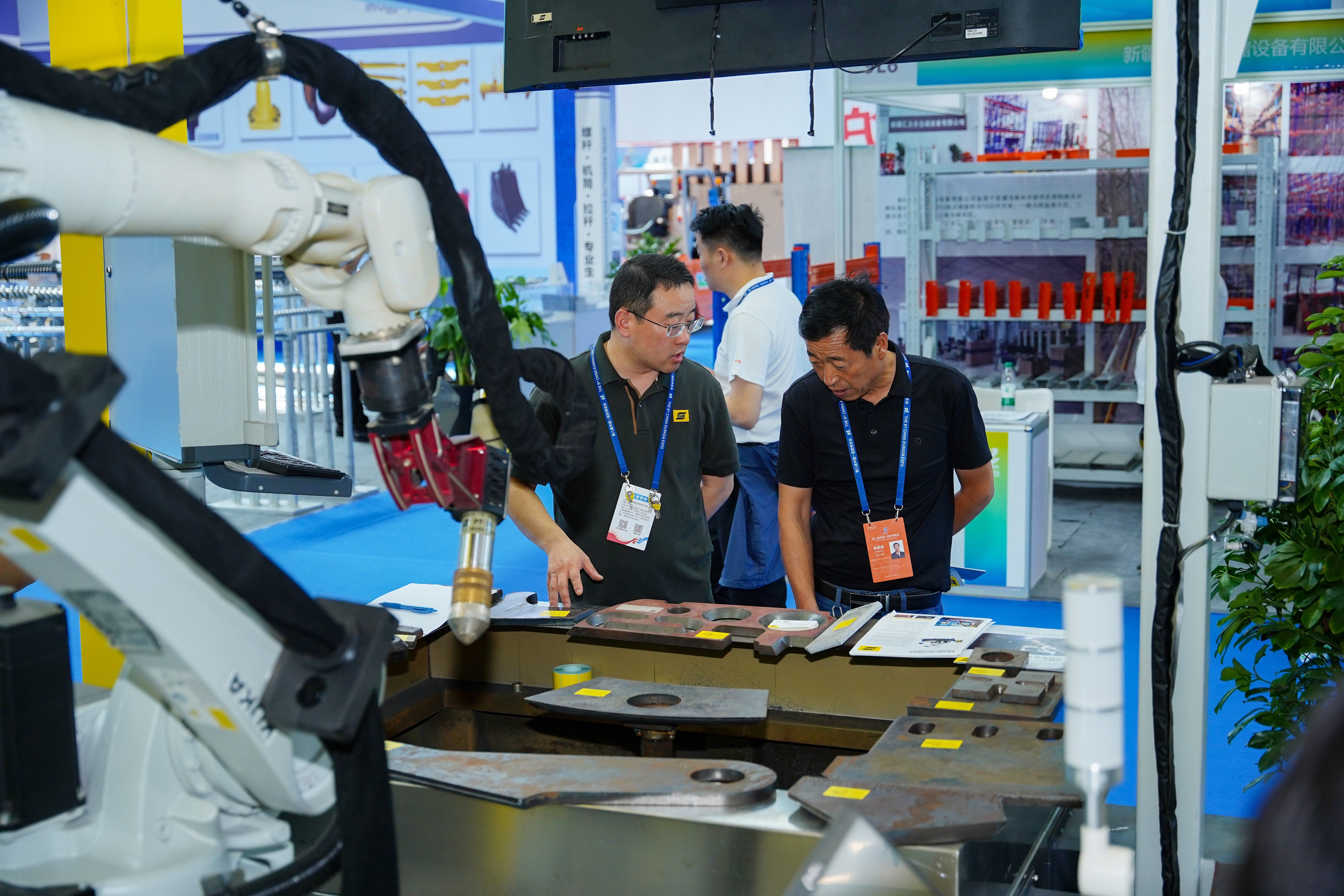 two men demonstrating cutting automation products.