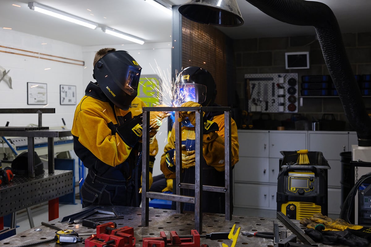 Welders MIG welding a metal frame