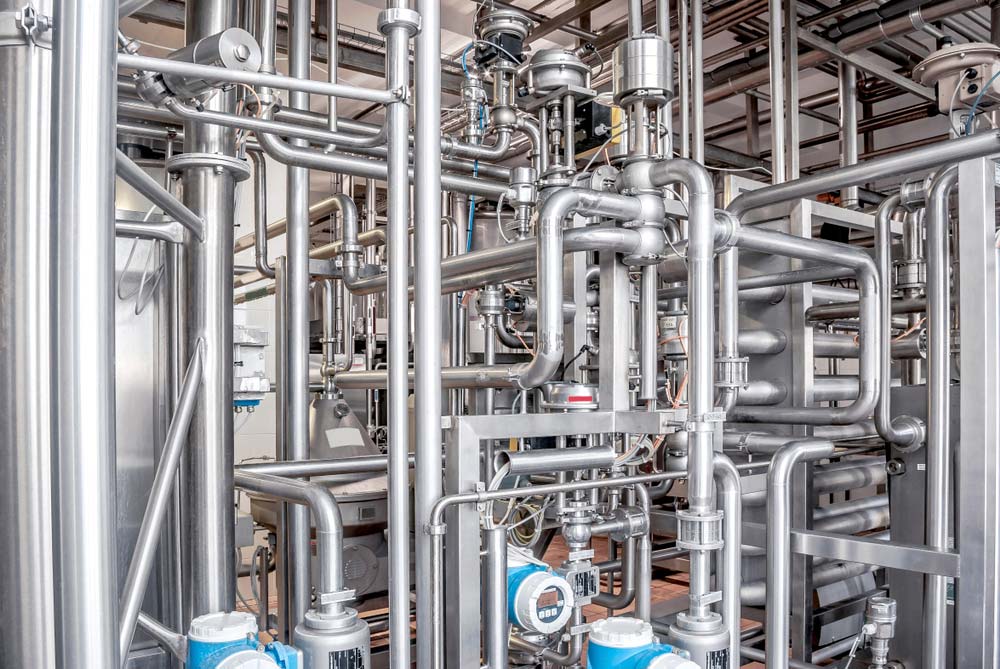 Stainless steel tubes in an industrial setting.
