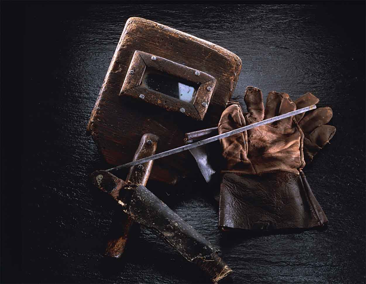 Historical welding helmet, gloves, and electrode