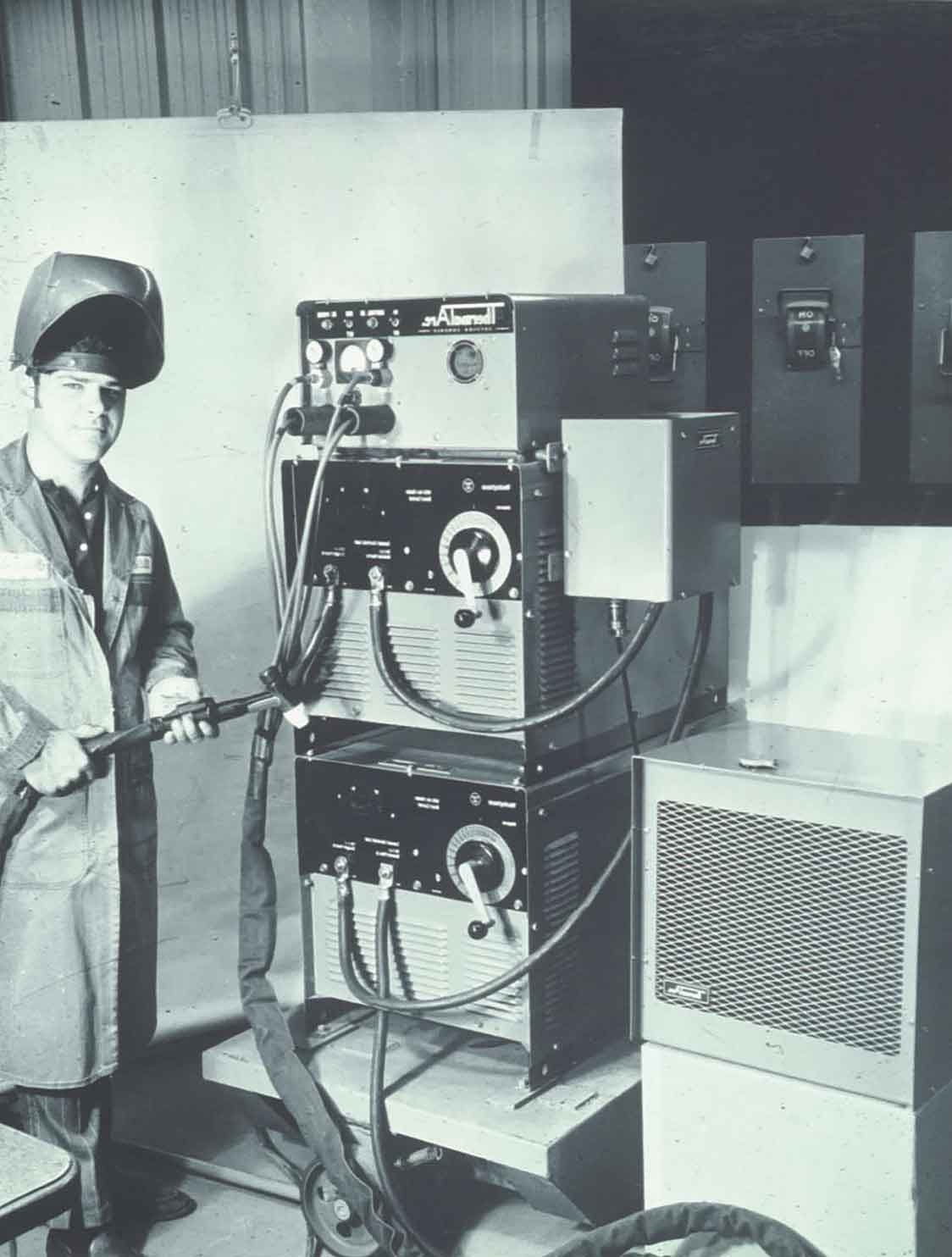 Welder standing beside the Thermal Dynamics PAK 40 power supply in 1970