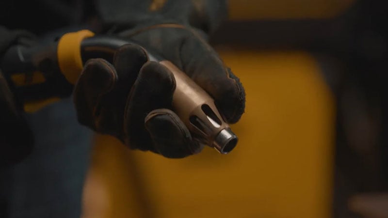 Tweco Centrovac fume extraction MIG welding gun nozzle held in gloved hand.
