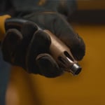 Tweco Centrovac fume extraction MIG welding gun nozzle held in gloved hand.