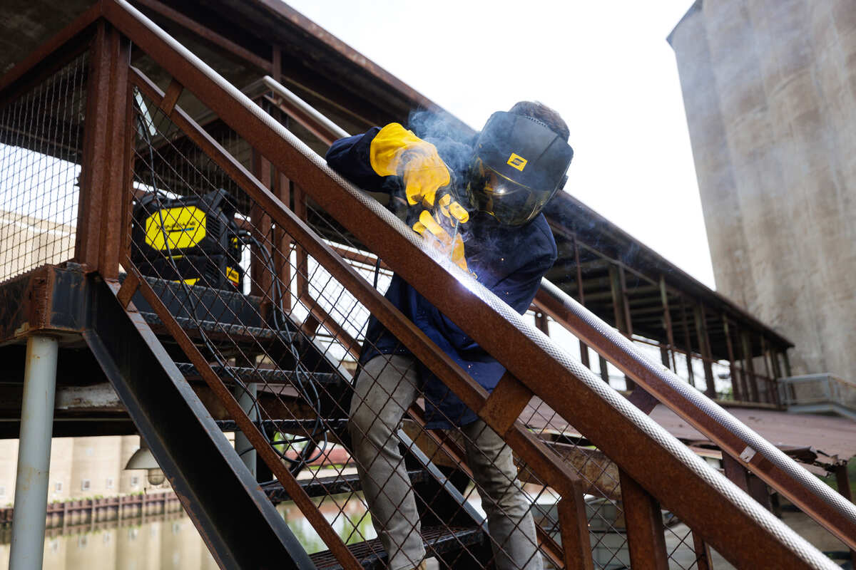 A welder using ESAB Renegade Volt in some steel stairs outdoors