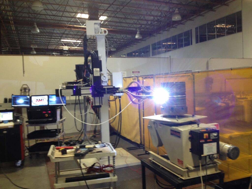 In a factory, a welding machine is actively being used.