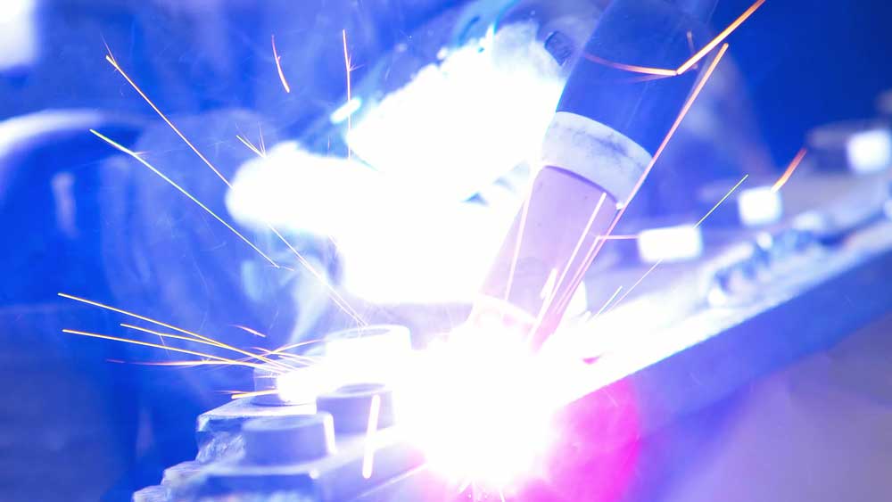 A GTAW torch with parts like the gas cup in use